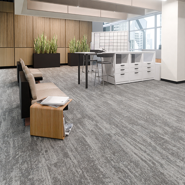 A modern office workspace featuring durable, noise-reducing carpet flooring installed by Dzire Decor.
